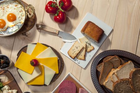 top view of a breakfast table with cheese, tomato, ham and breadの写真素材