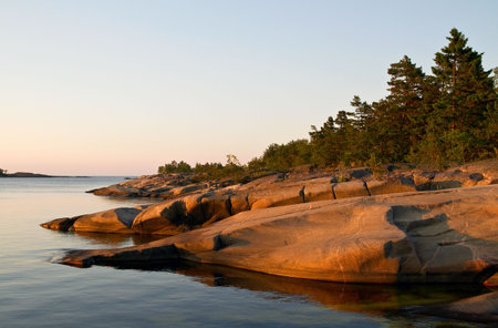Sunlit rocks on a summernight.の写真素材