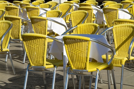 Outdoor cafe with yellow chairs in summer の写真素材