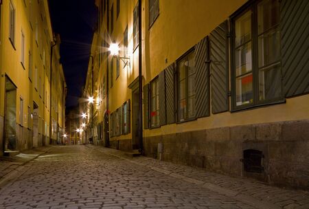 Empty cobblestone alley at night.の写真素材
