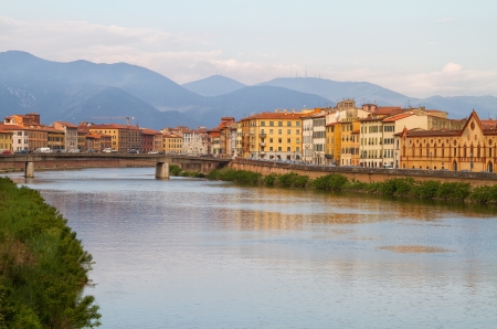 River Arno floating through the medieval city of Pisa.の写真素材