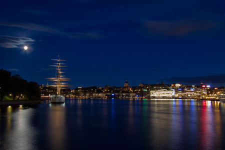 Vintage ship and city lights at night 