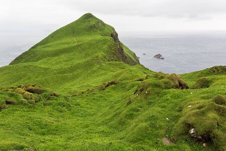 Green dramatic landscape on Faroe islands in summer.の写真素材