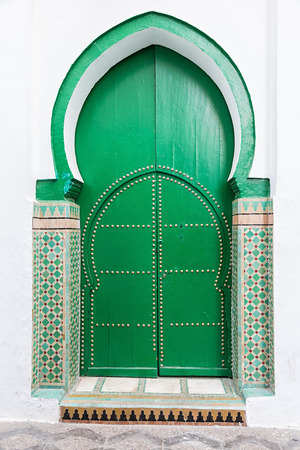 Ancient green wooden door leading to a mosque.の写真素材