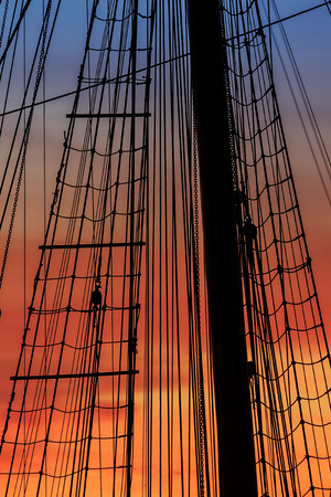 Mast and rigging details from a vintage ship at sunset.の写真素材