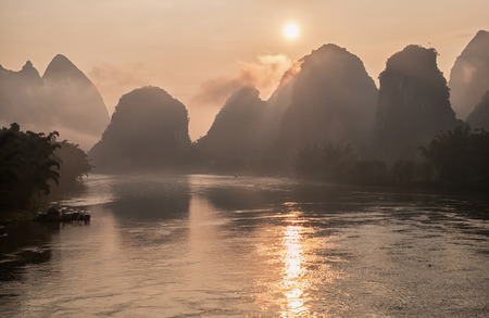 Li river in mist at sunrise. Yangshuo, China.の写真素材