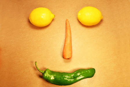 face made with vegetables, lemon, carrot and pepperの写真素材