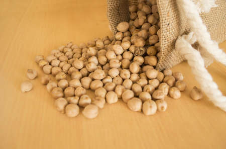 Pile of chickpeas beans  isolated on wood backgroundの写真素材