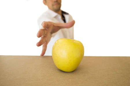 catching an appel man that is on the tableの写真素材