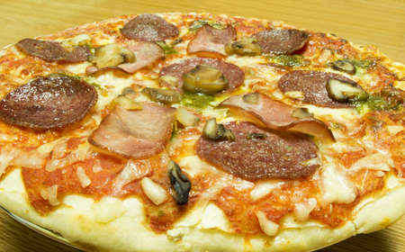Pizza with Pepperoni and ham in close-upの写真素材
