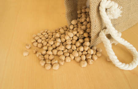 Pile of chickpeas beans  isolated on wood backgroundの写真素材