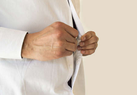 Detail view of  businessman adjusting her shirt buttonsの写真素材