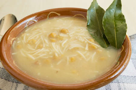 Bowl of chicken and chickpea soup.の写真素材