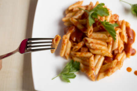 close up of a fork with punctured penneの写真素材