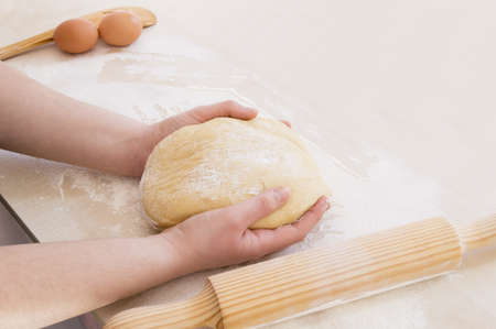 taking the dough with both handsの写真素材