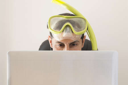 Man smiling at web prices for your holidays and tripsの写真素材