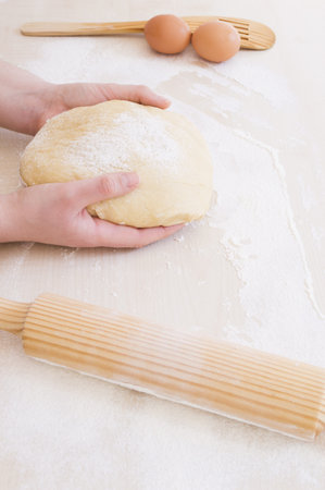 taking the dough with both hands