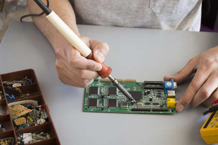 welding process of a resistor on a electronic board の写真素材
