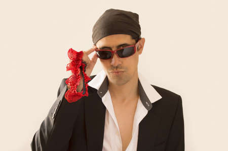 parody of a Latin lover with a garter red  in handの写真素材