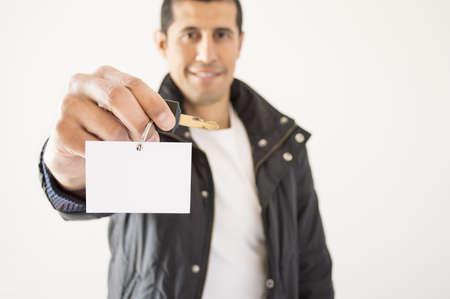Biker offering a card keys with copy spaceの写真素材