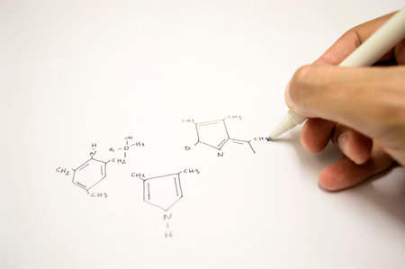 Close up of a hand drawing molecular structure scheme