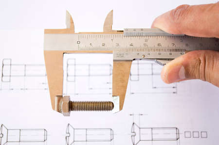 hand with Steel caliperand planes in close upの写真素材