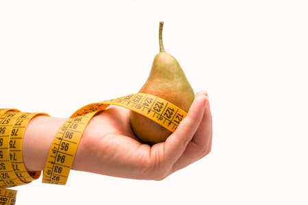 woman hand  showing measurement tape and fresh green pearの写真素材