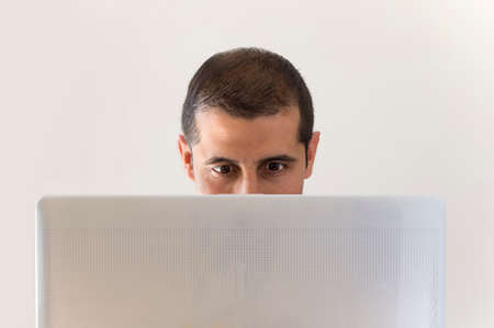 close up of a man smiling while looking at the  laptop with white backgroundの写真素材