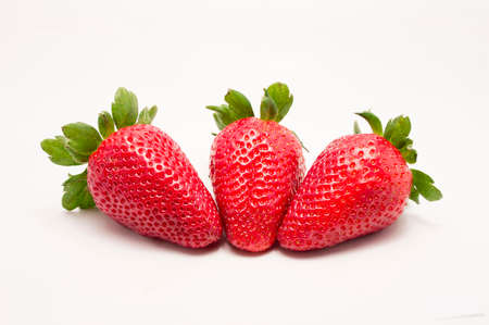 close up of three fruits strawberries in white backgroundの写真素材
