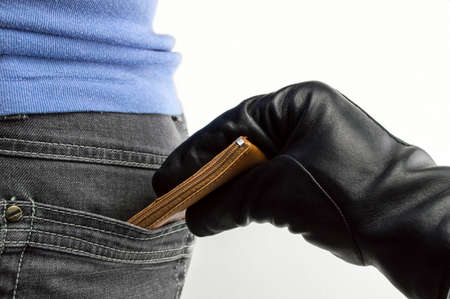 close up of a the hand of a thief stealing the money to a womanの写真素材
