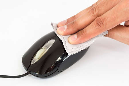 hand of a man cleaning a dirty mouseの写真素材