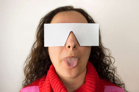woman who sees reality sticking out her tongue  with copy spaceの写真素材