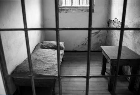 old abandoned with bed inside cellの写真素材