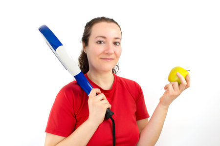 paddle tennis player woman showing an apple as healthy foodの写真素材