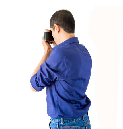 man photographing with camera isolated over white backgroundの写真素材