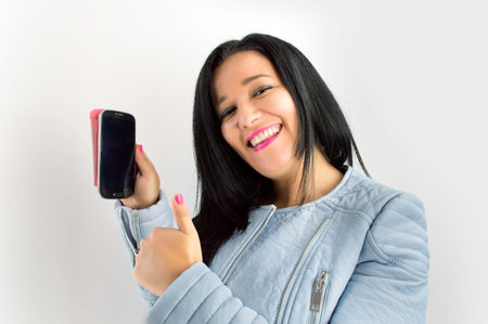 woman showing her phone and thumbs up