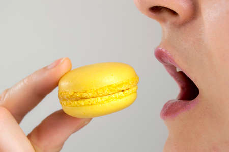 Close-up of a woman eating macaronの写真素材