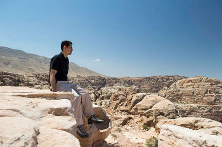 man hiker enjoying view of mountain in Jordan の写真素材