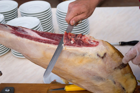 iberic ham cutter cutting ham for diners in a restaurantの写真素材