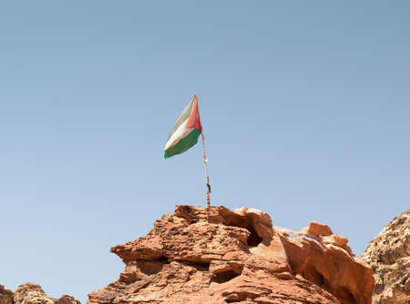 Jordan flag on the peak of a mountain in Petraの写真素材