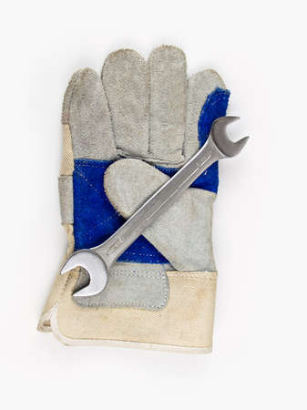 work gloves and wrench with white backgroundの写真素材