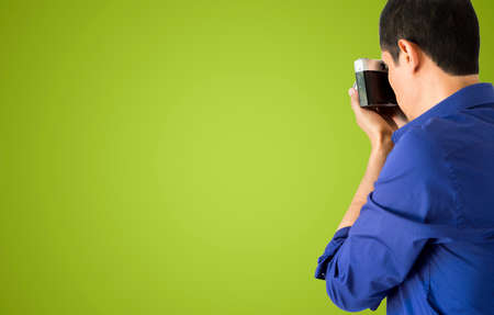 Man photographing with green backgroundの写真素材