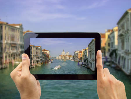 close up of hand photographing the Great Channel in Venice Italyの写真素材