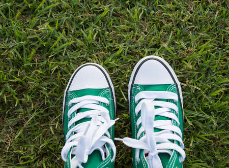 Green shoes on the grass with copy spaceの写真素材