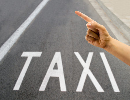 Hand indicating calling a taxi to stopの写真素材