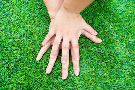 child by comparing the size of your hand with his motherの写真素材