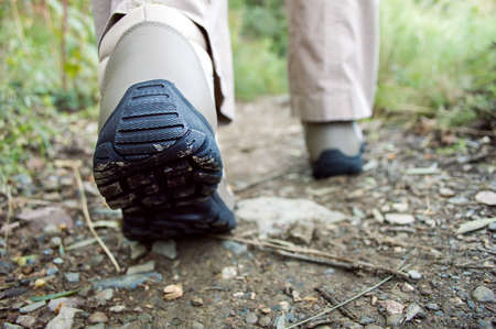 Cropped rear view of a hiker walking along a trailの写真素材