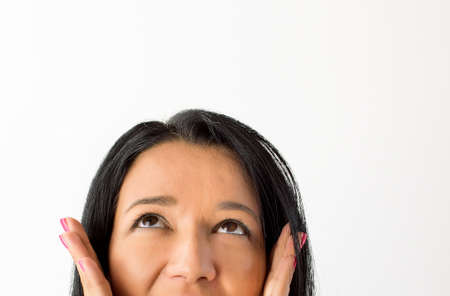 Thoughtful beautiful woman on whiteの写真素材