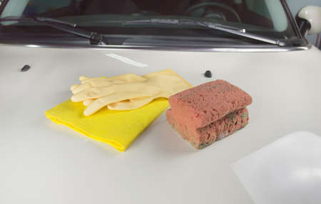gloves cloth and sponge over the car for washingの写真素材