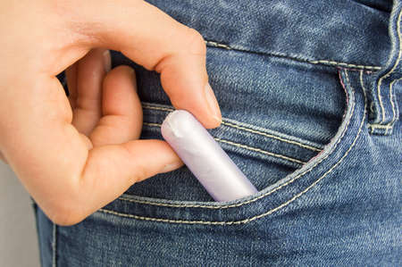 cropped  shot of a woman s pocket taking tamponの写真素材